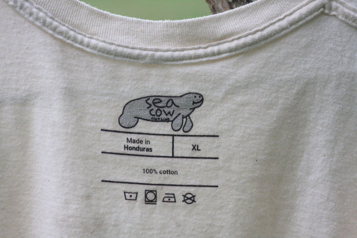 Gray t-shirt with a graphic of a 'sea cow' and text on the fabric.